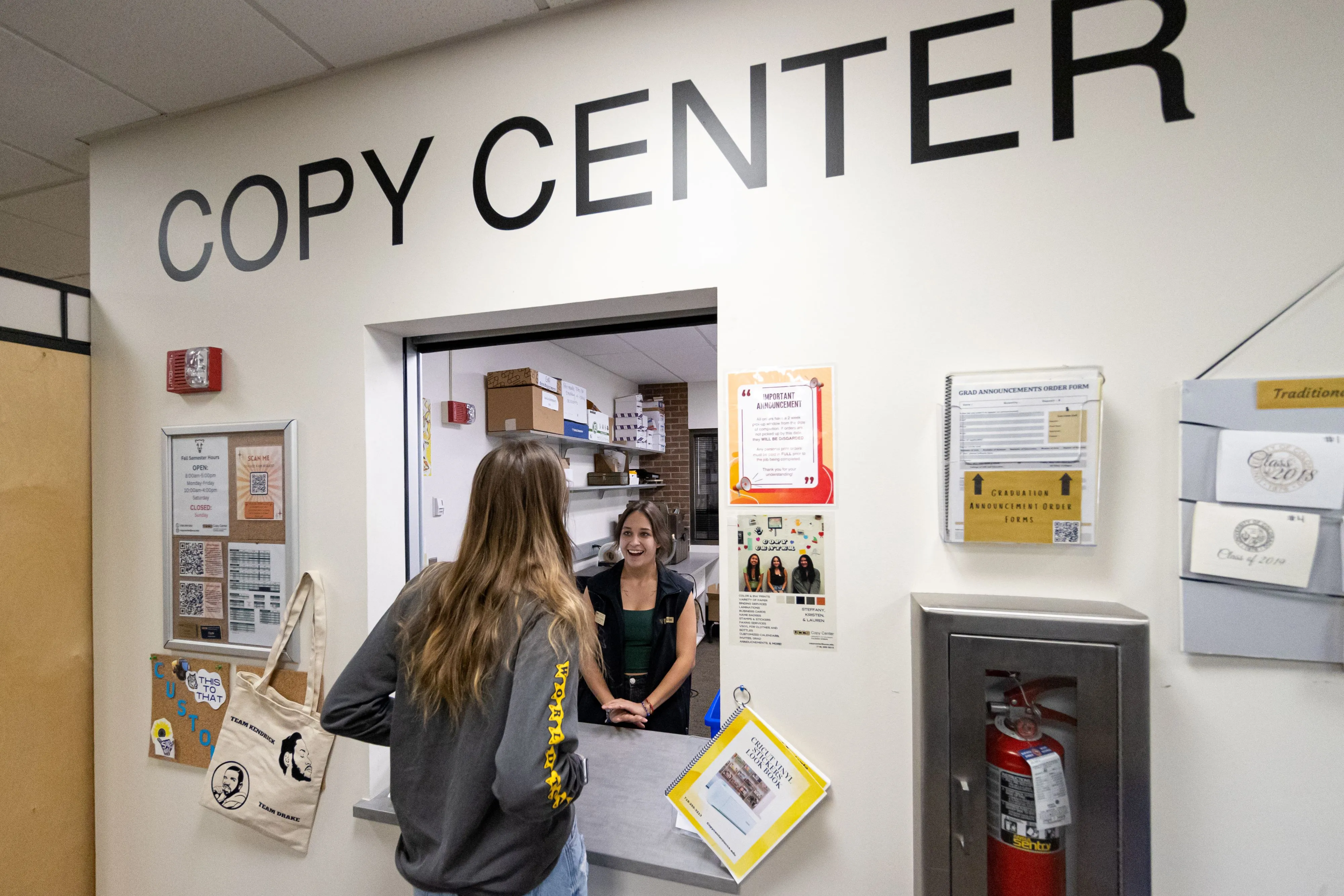 A Copy Center Employee helping a customer